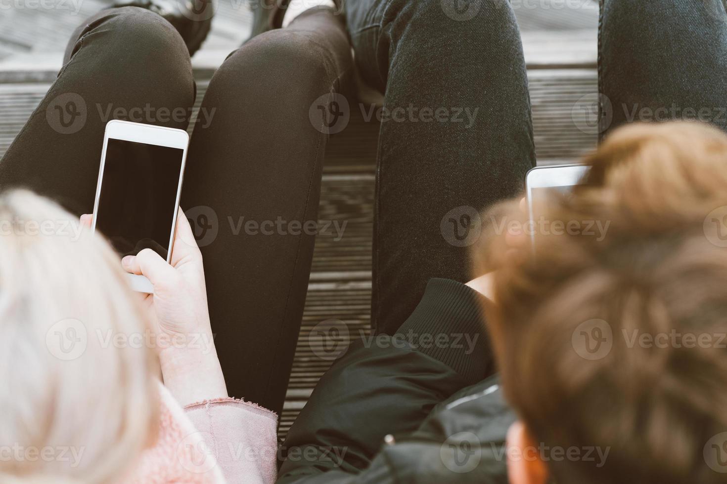 Teenage love concept. Cute brunette guy young blonde girl photo