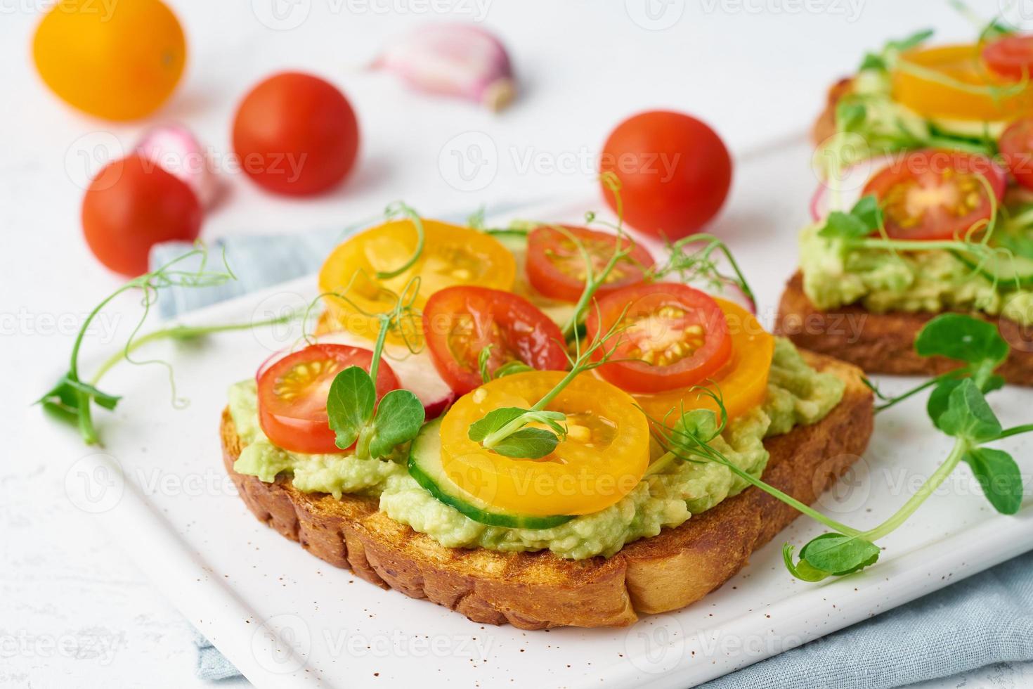 avocado toast with cherry tomatoes and herbs, breakfast, closeup photo