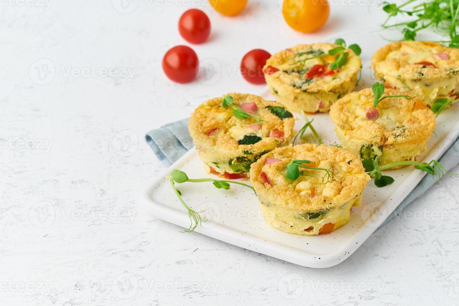 omelet with tomatoes and bacon, baked eggs with spinach and broccoli photo