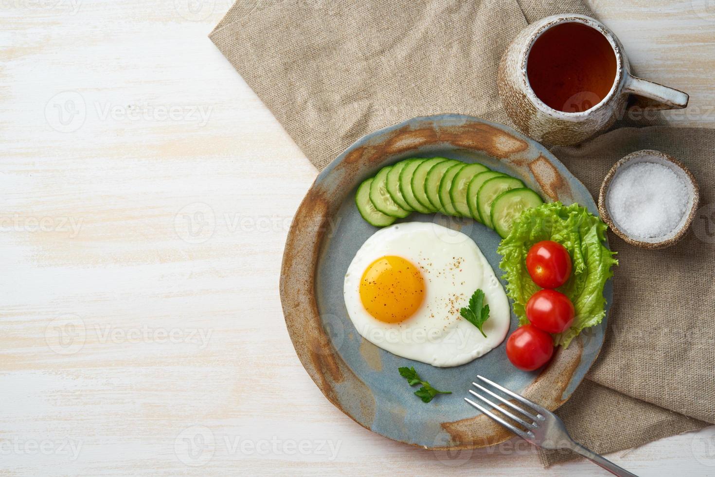 Fried egg, vegetables. Paleo, keto, fodmap diet. Copy space, top view. Healthy diet concept photo