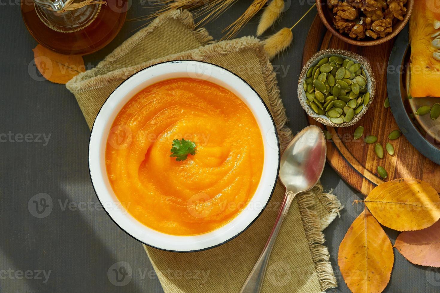 Pumpkin creamy soup with walnuts, season dish, healthy dieting recipe photo