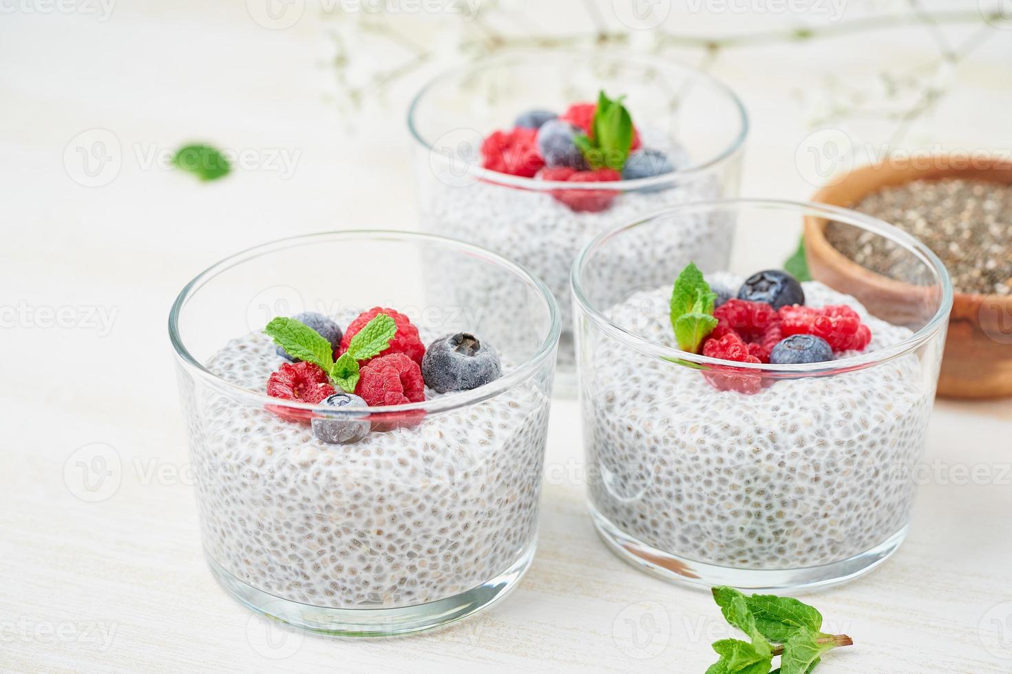 Banner with Chia pudding in bowl with fresh berries raspberries, blueberries. photo