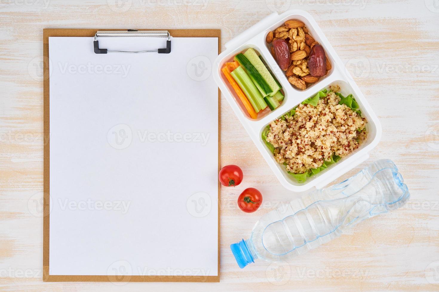Clipboard, vegan lunch box, bottle. Healthy vegetarian menu, weight loss, healthy lifestyle photo