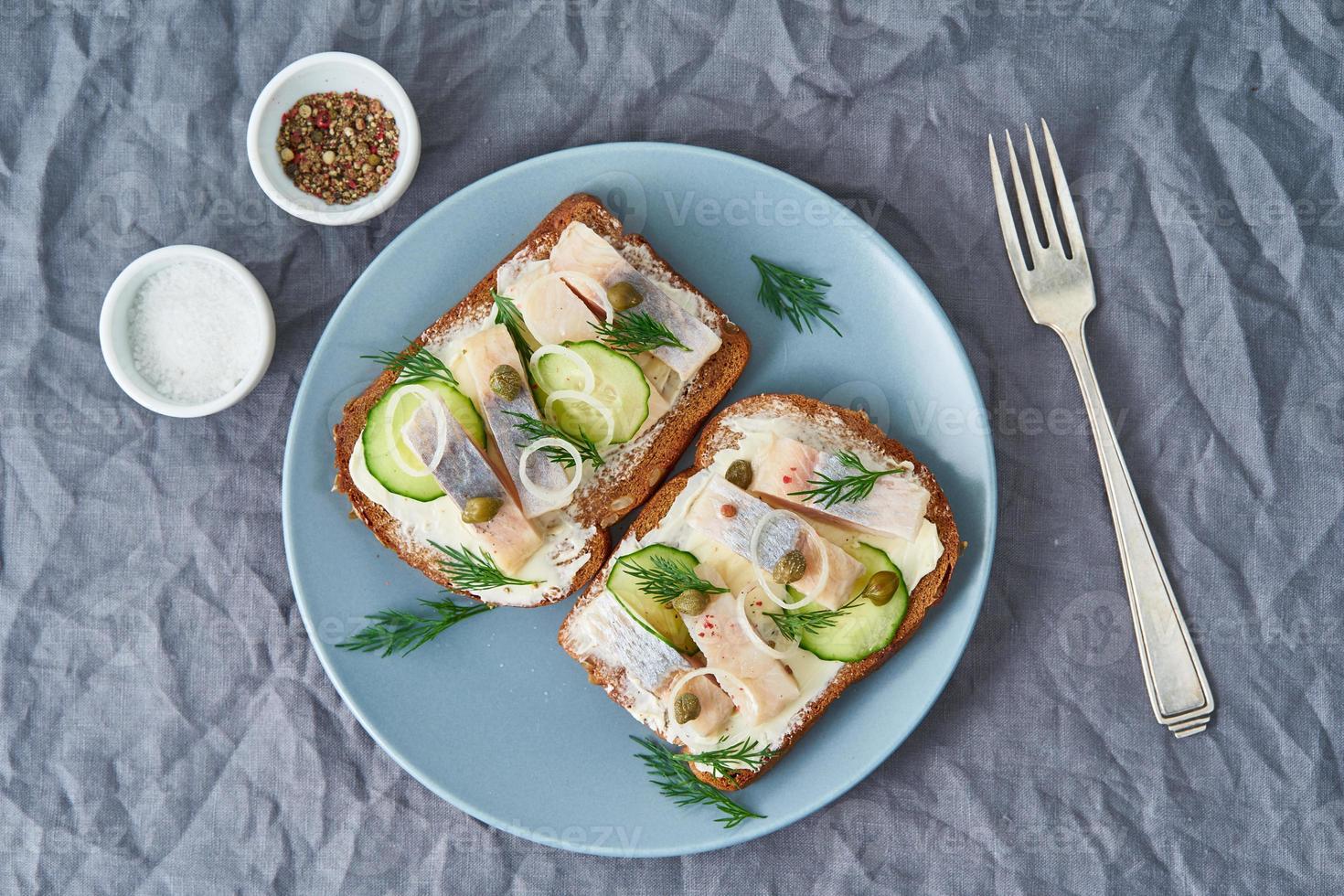 Herring smorrebrod - traditional Danish sandwiches. Black rye bread with herring photo