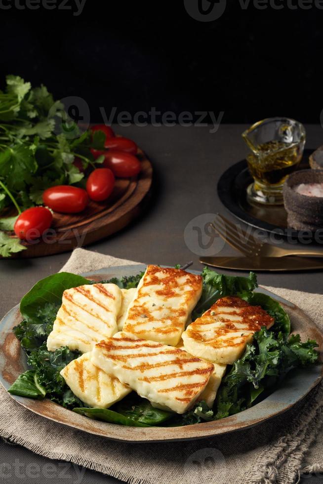 Cyprus fried halloumi cheese with healthy green salad. Lchf, pegan, fodmap, paleo, scd, keto diet. photo