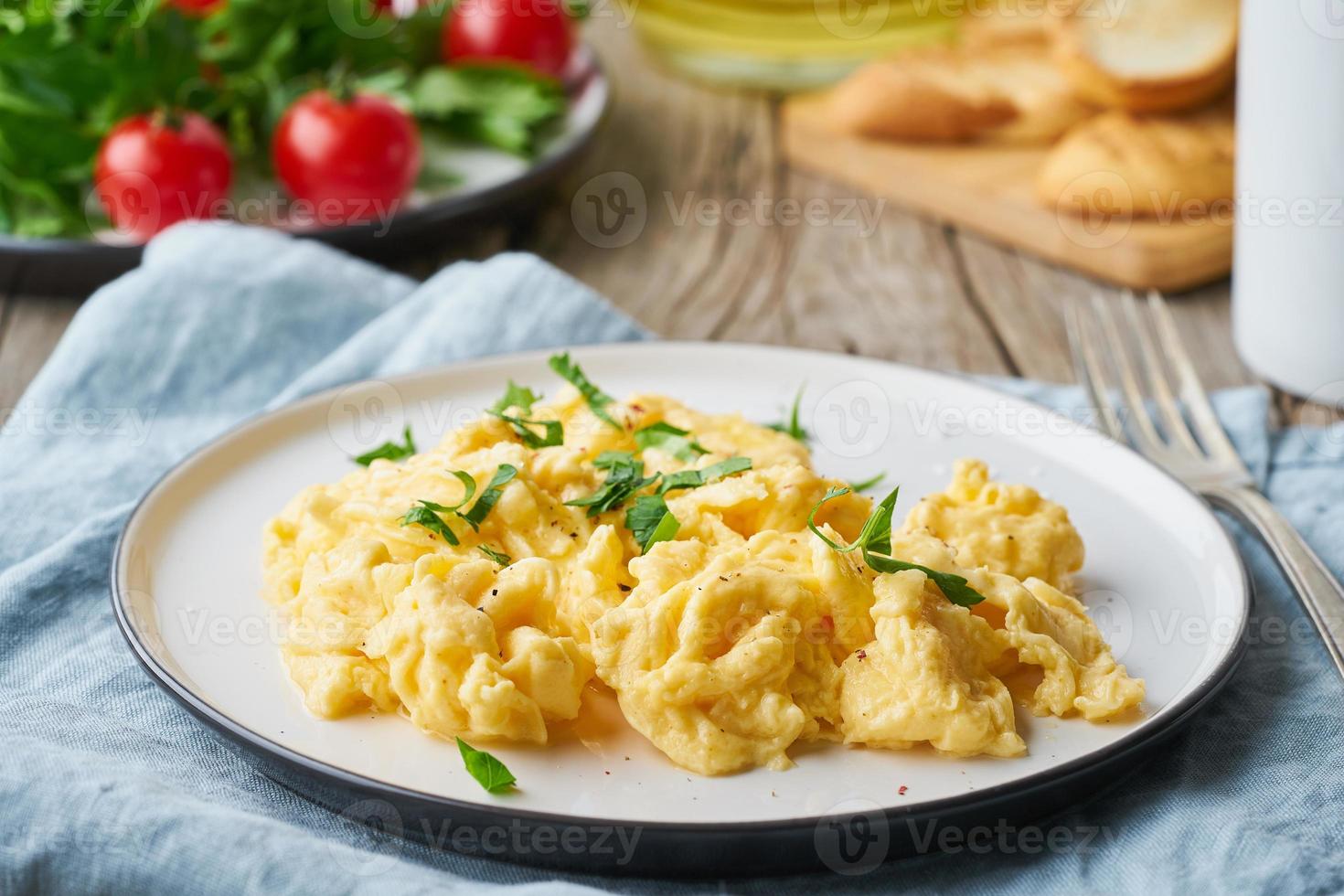 Scrambled eggs, omelette, side view. Breakfast with pan-fried eggs photo