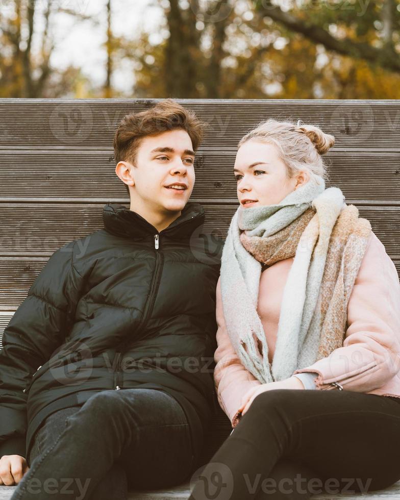 Teenage love concept. Cute brunette guy young blonde girl photo