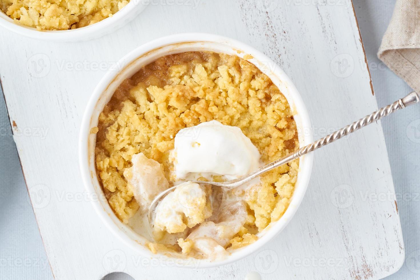 Apple crumble with ice cream, streusel. Morning breakfast on a light gray table. Top view, close up photo