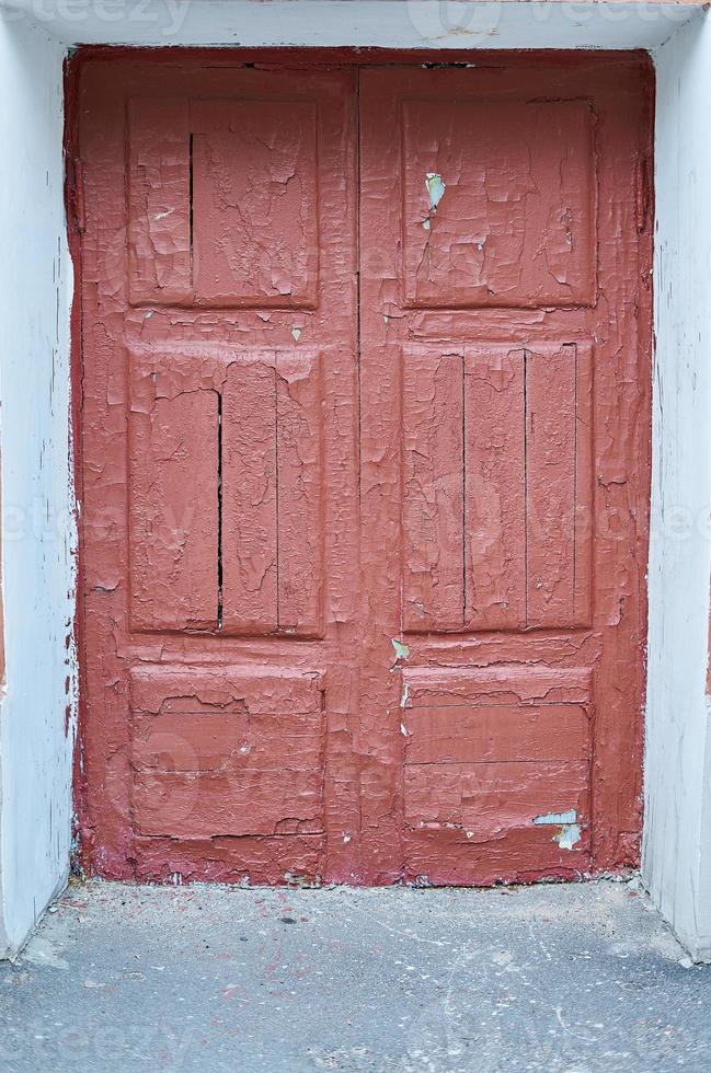 old cracked red door on the front of the house photo