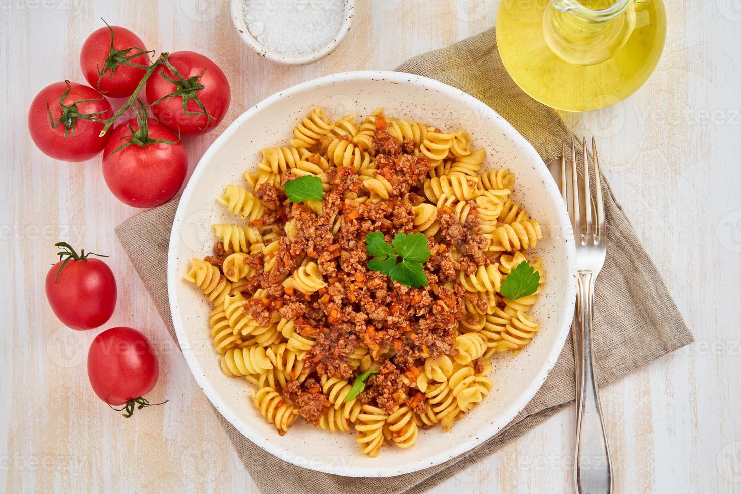 Bolognese pasta. Fusilli with tomato sauce, ground minced beef. photo