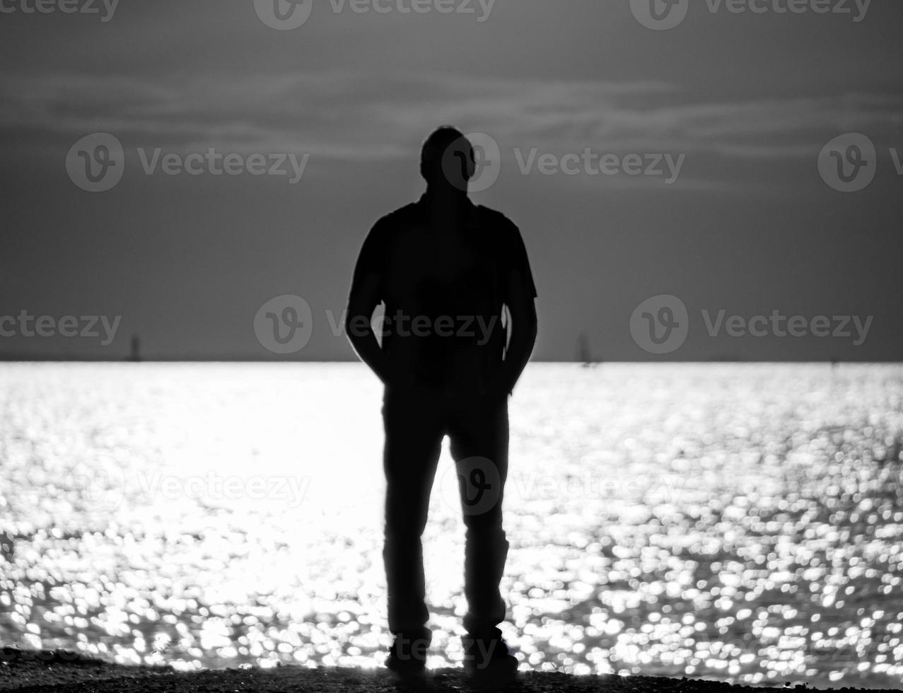 silhouette of man on the Gulf of Finland in St. Petersburg, a man looking into the distance photo