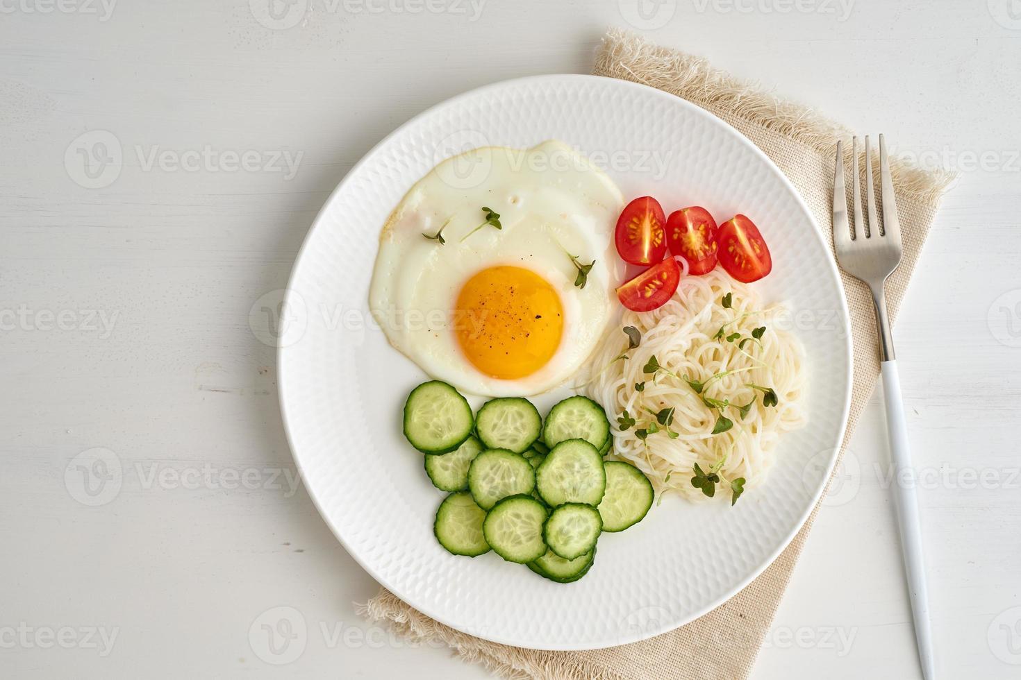 Healthy breakfast - fried egg with cherry tomatoes and cucumber photo
