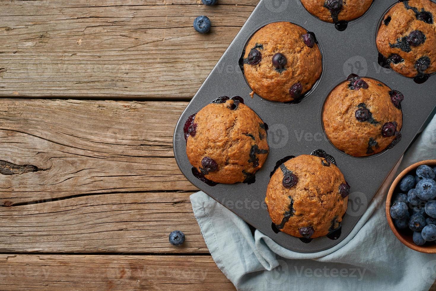 Blueberry muffin in tray, copy space. Cupcakes with berries in baking dish photo