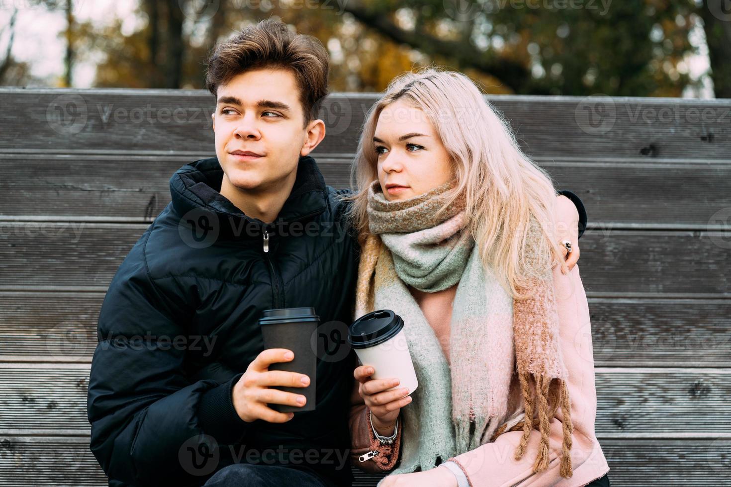 Teenage love concept. Cute brunette guy young blonde girl photo