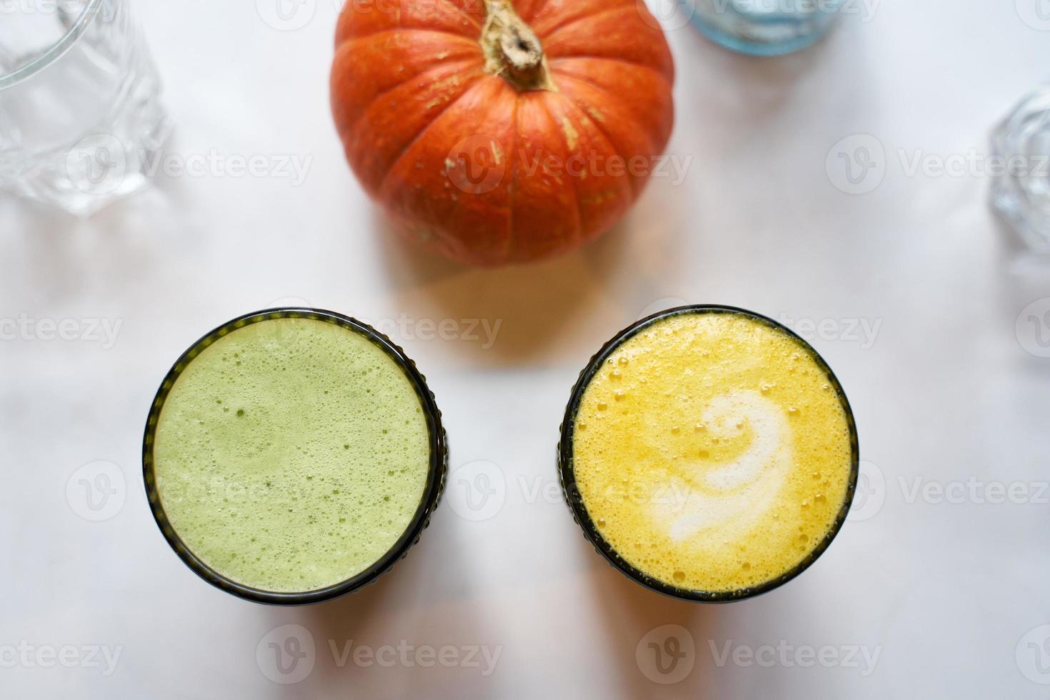 Healthy drink turmeric and ginger yellow latte with coconut milk and vegan matcha latte with green tea and oat milk, top view, white background photo