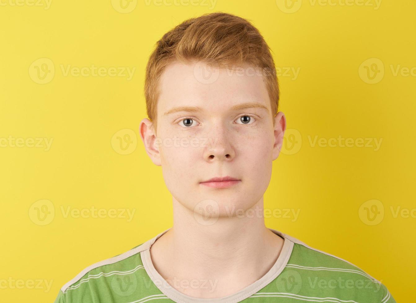 Irish redhead teenager on yellow background closeup photo