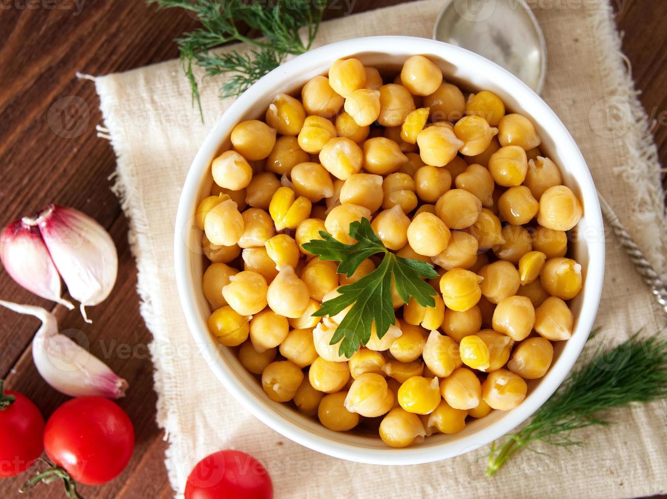 Cooked Chickpeas on bowl on dark wooden table. Healthy, vegetari photo