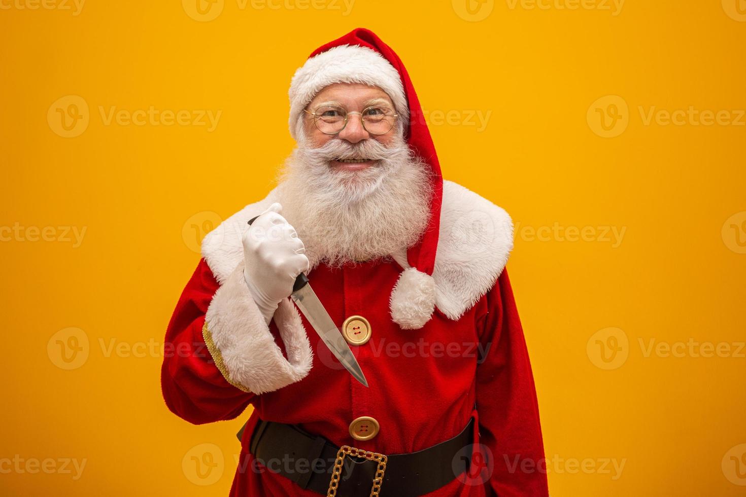 Santa Claus holding a knife. Evil Santa Claus concept. Murder. photo