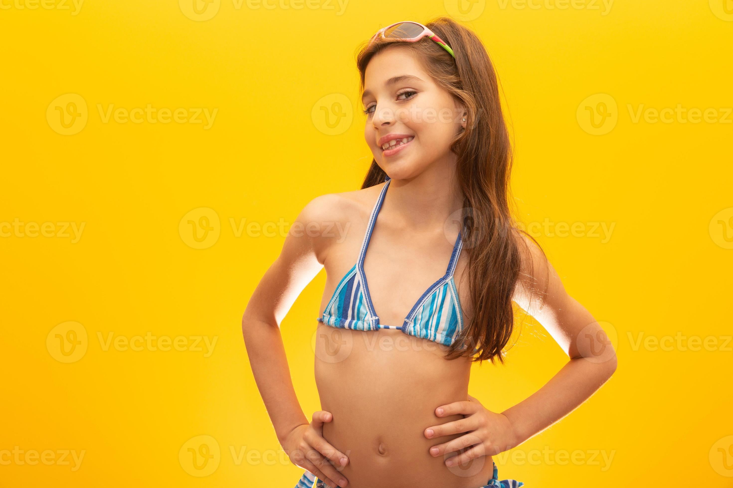 child on beach biquini Child wearing bikini on yellow background. Concept of summer, beach and  pool. 7547796 Stock Photo at Vecteezy