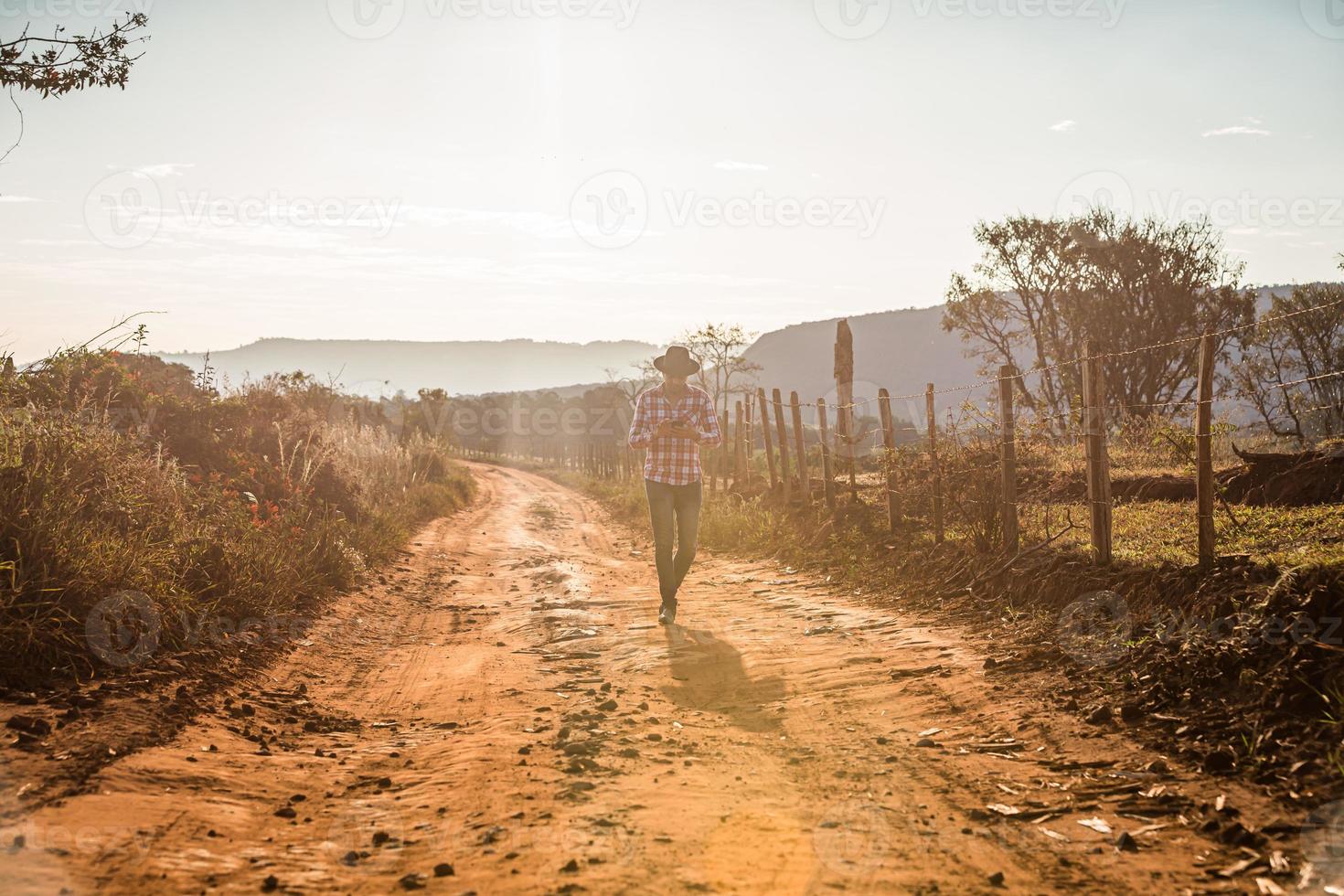 Farmer or country man using a smartphone on the farm. Internet 4G farmer. Social networks, online consultations. photo