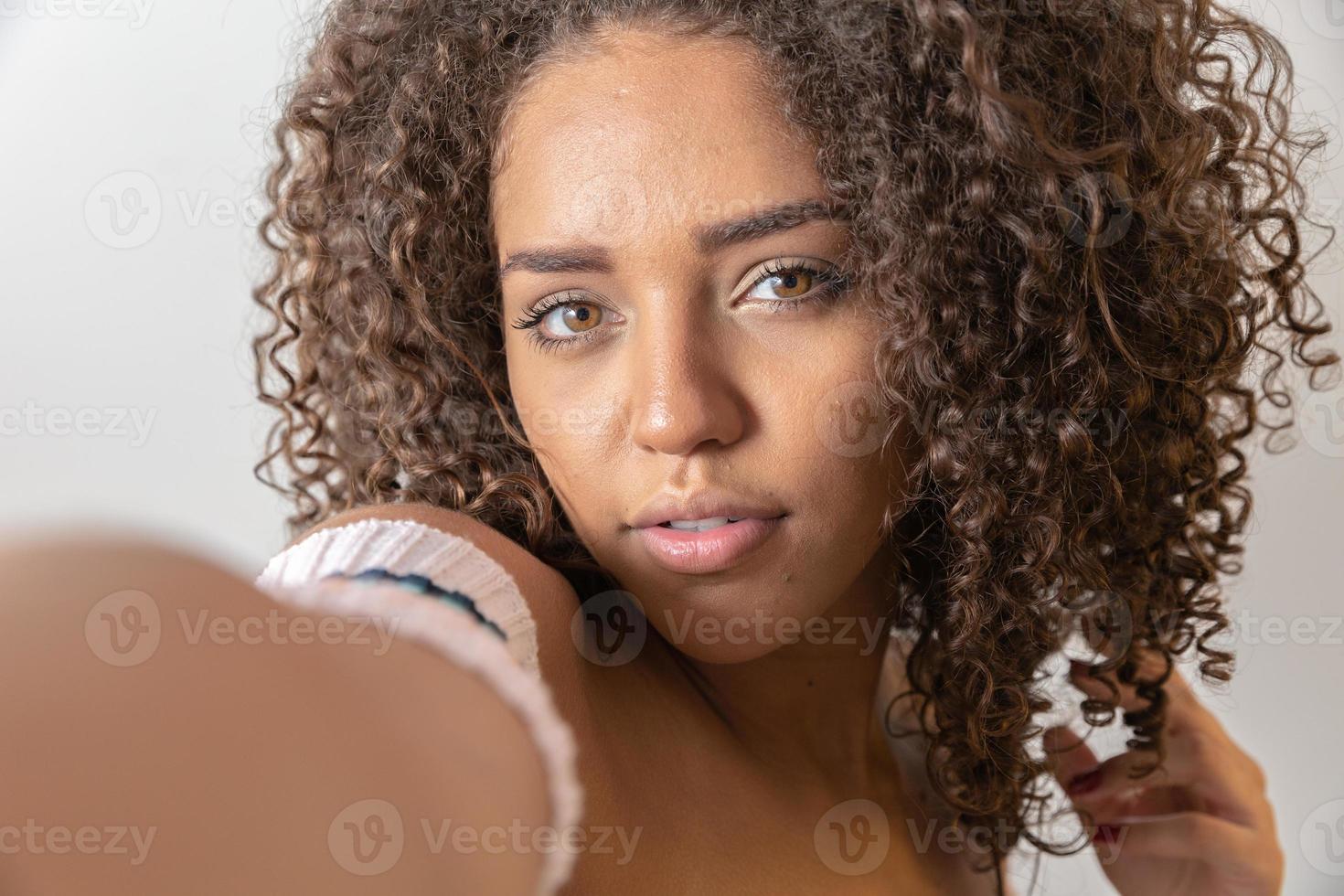 Selfie portrait of cheerful black woman in studio with curly hair 7547886 Stock Photo at Vecteezy