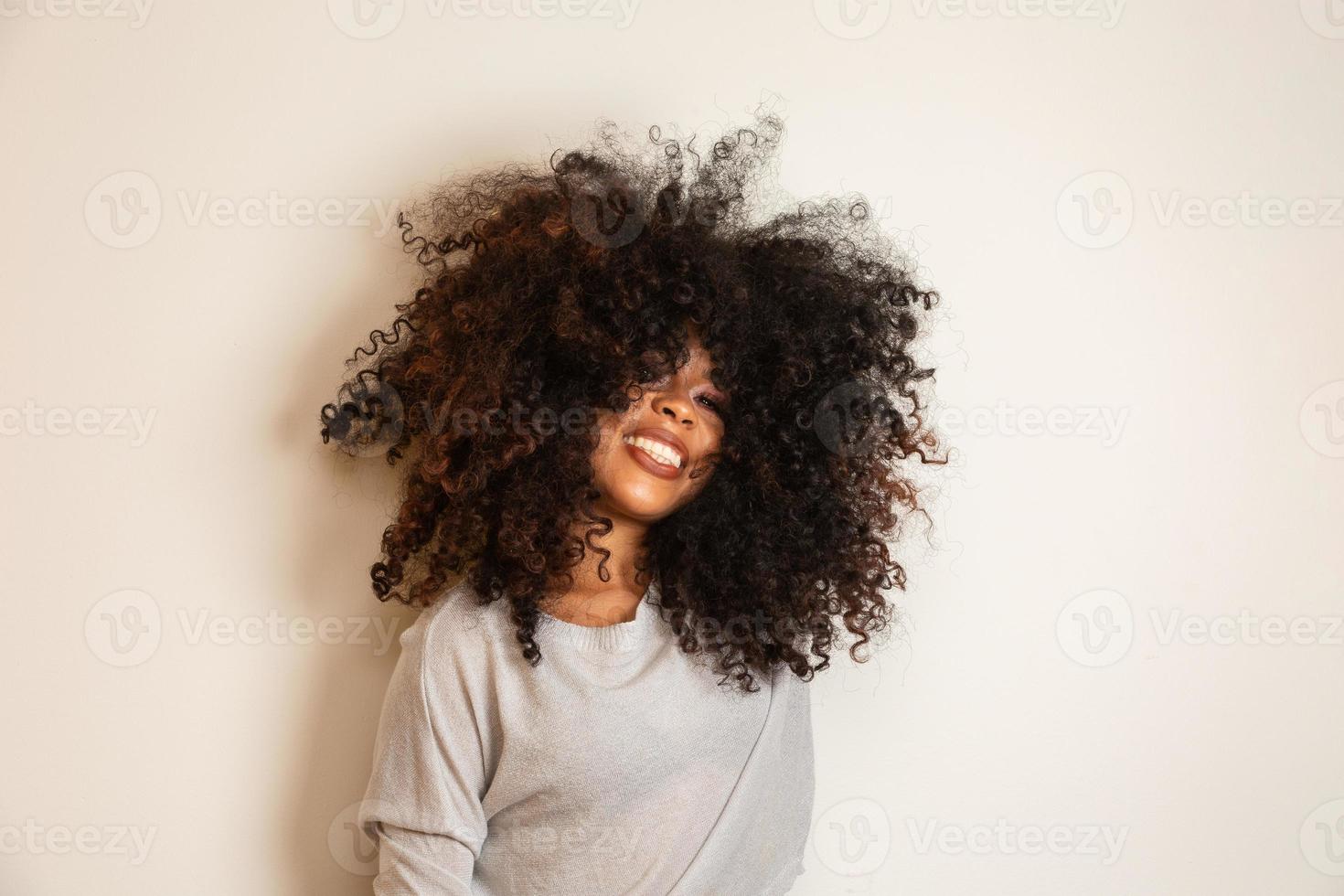 Beauty portrait of african american woman with afro hairstyle and glamour makeup. Brazilian woman. Mixed race. Curly hair. Hair style. White background. photo