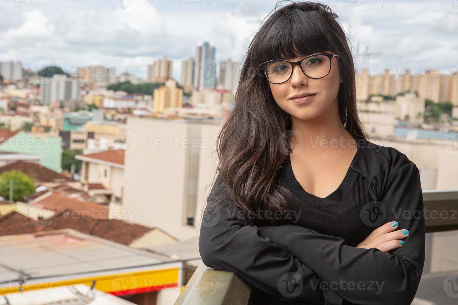 Successful smile businesswoman on top of a building. photo