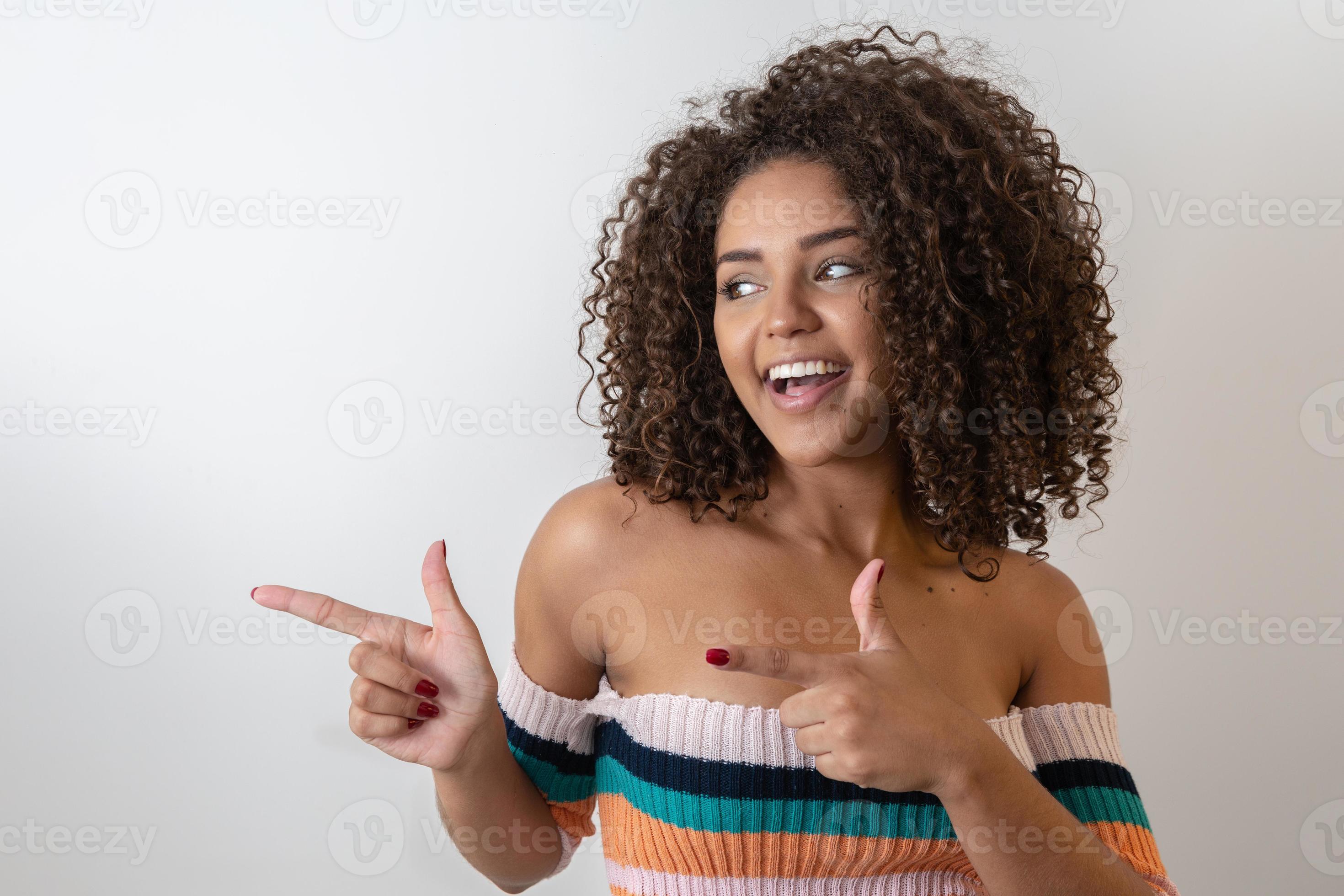 Young beautiful african woman presenting your product. Beautiful african  american model woman pointing and presenting beside on a white background.  7547981 Stock Photo at Vecteezy