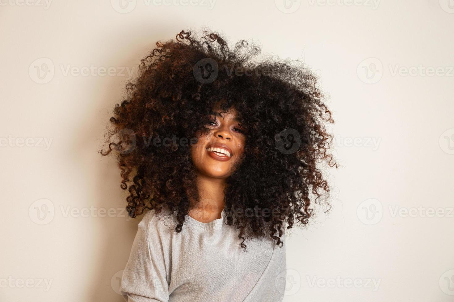 Beauty portrait of african american woman with afro hairstyle and glamour makeup. Brazilian woman. Mixed race. Curly hair. Hair style. White background. photo