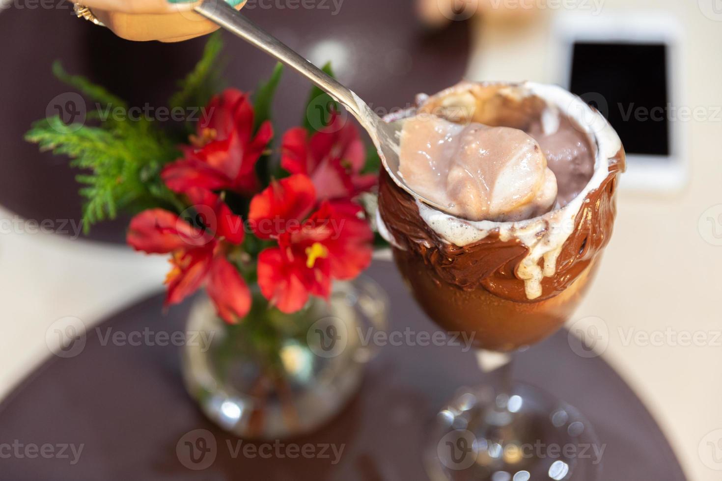 Ice cream white blends strawberry with high calories, can make you fat, soft focus, blurred. Delicious vanilla or chocolate sundae with strawberry. photo
