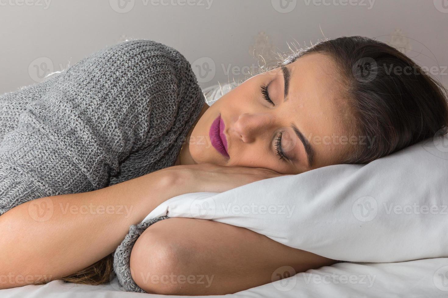 Beautiful woman sleeping on comfortable pillow in bed at home photo