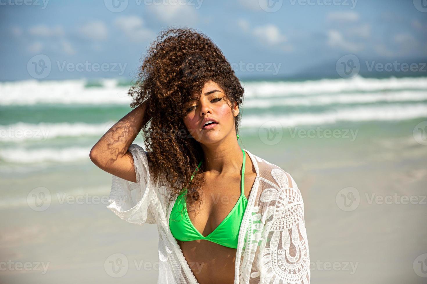 Black afro young cute girl, curly hair, bikini, beach. Afro American summer vacation holiday. photo