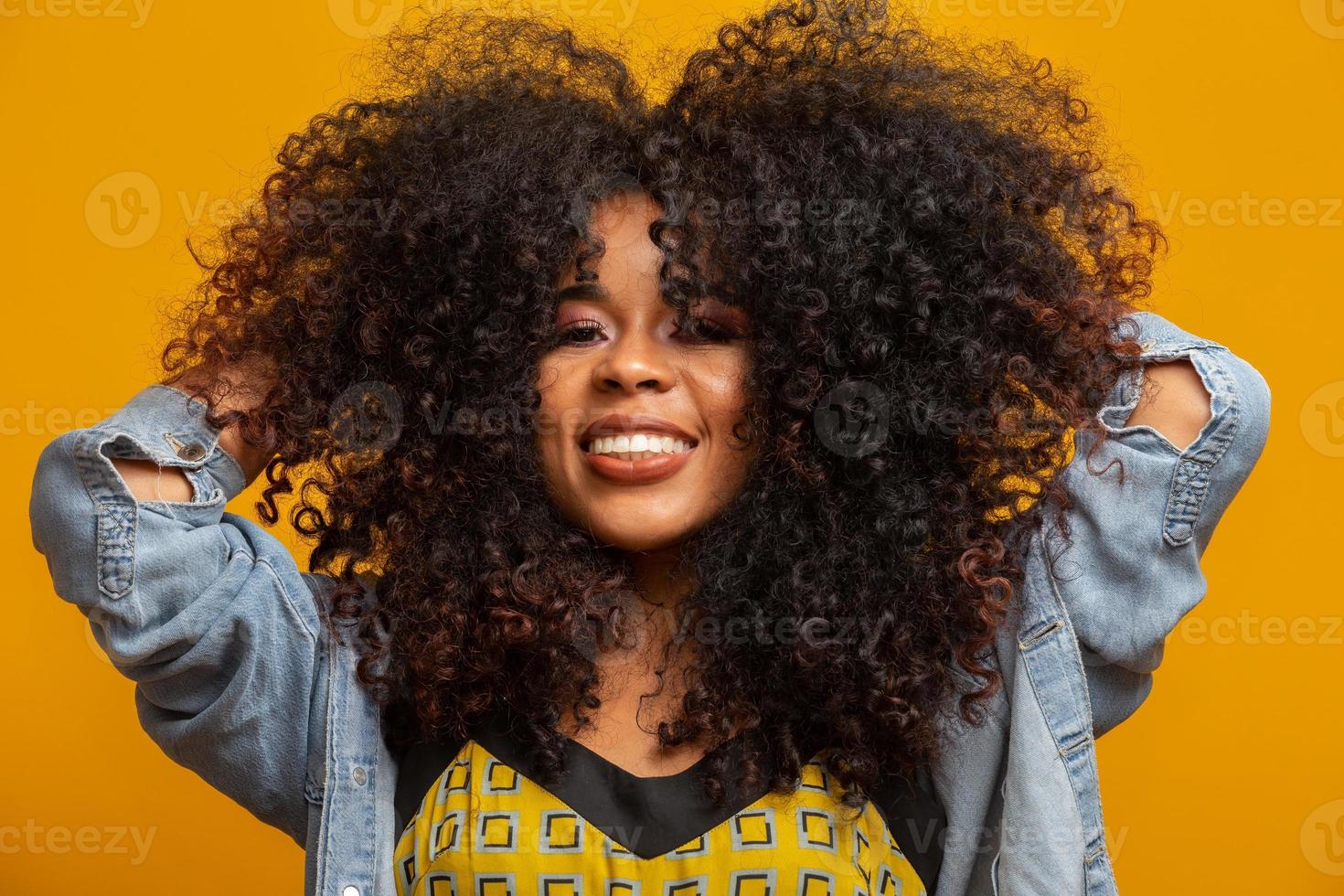 Beauty portrait of african american woman with afro hairstyle and glamour  makeup. Brazilian woman. Mixed race. Curly hair. Hair style. Yellow  background. 7548309 Stock Photo at Vecteezy