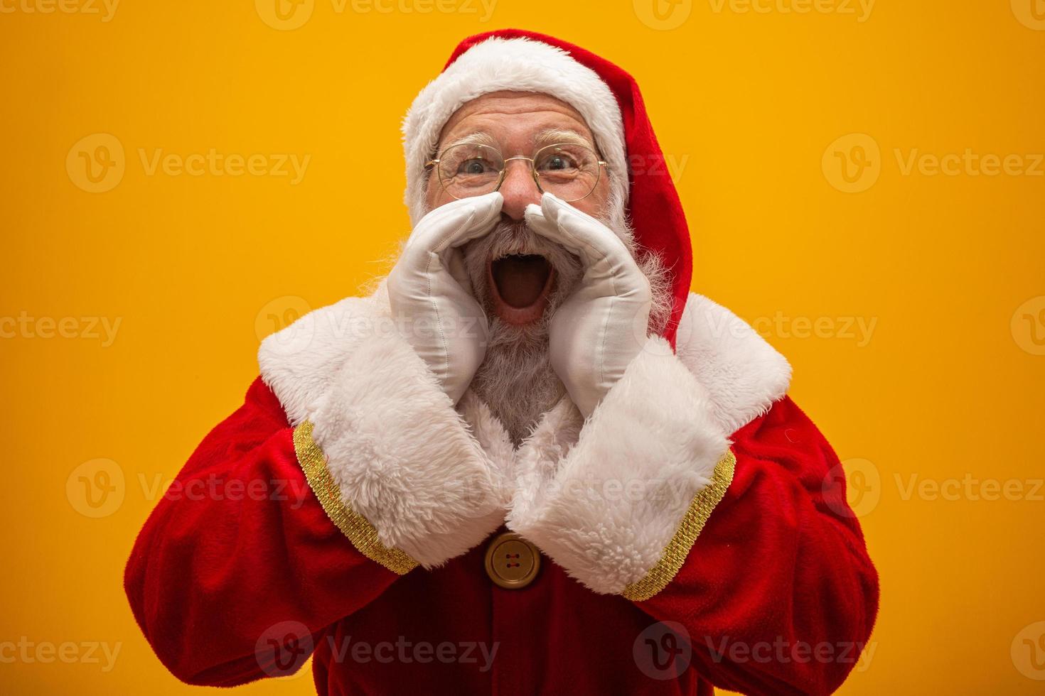 Communication concept. Profile side view photo of excited funny kind stylish Santa Claus with open mouth hold palm hand near face saying loud ho-ho-ho isolated on vivid yellow background