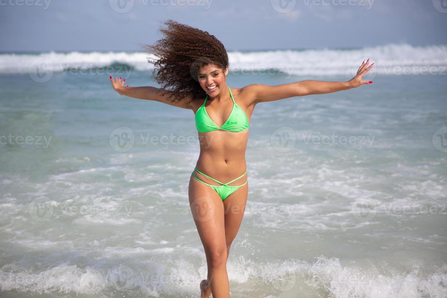 Black afro young cute girl, curly hair, bikini, beach. Afro American summer vacation holiday. photo
