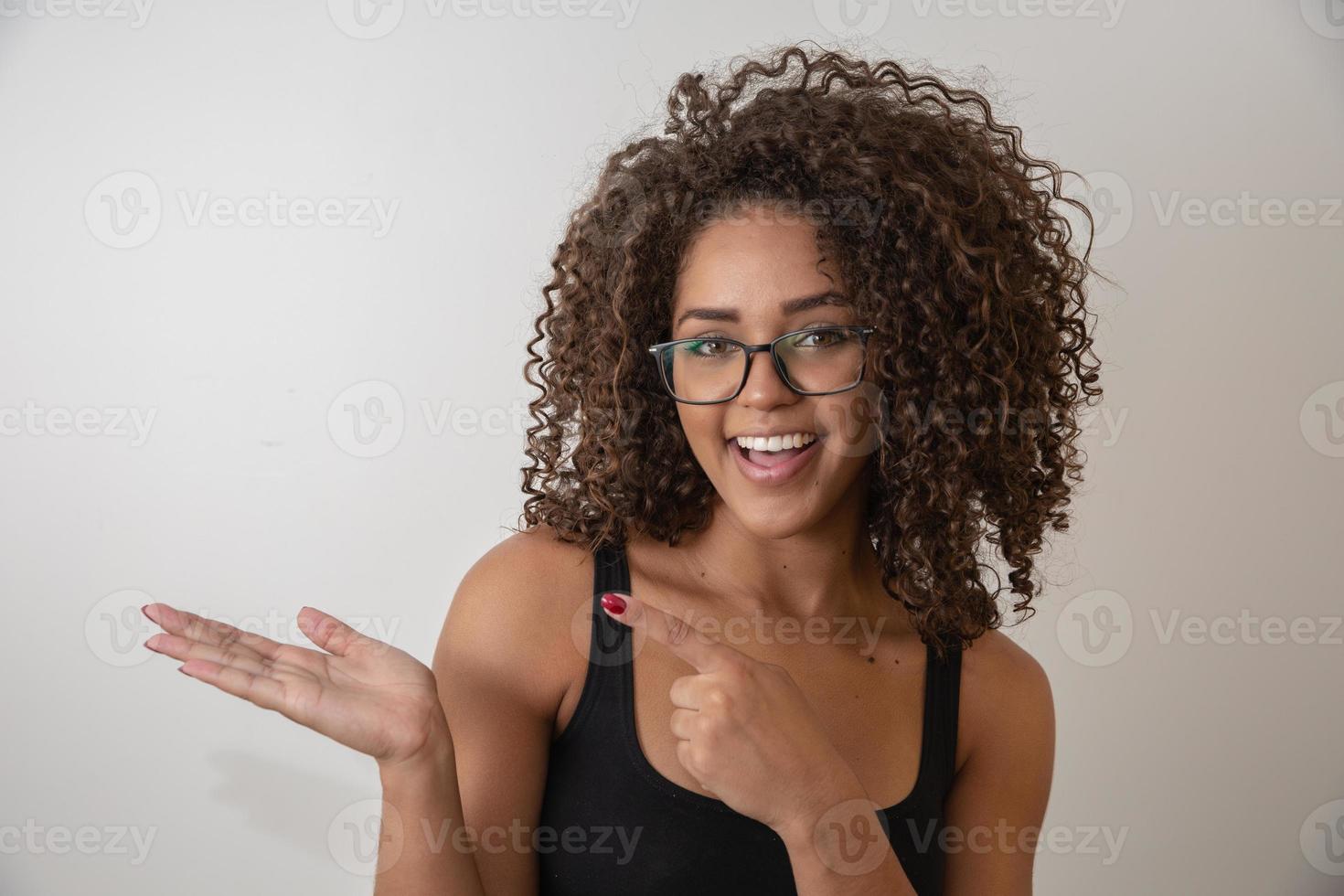 Portrait of young beautiful african american girl with afro. Girl wearing eyeglasses. Closeup. Studio shot. photo