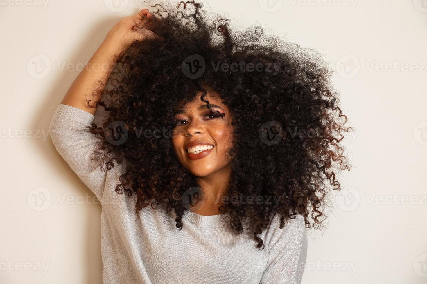 Beauty portrait of african american woman with afro hairstyle and glamour makeup. Brazilian woman. Mixed race. Curly hair. Hair style. White background. photo