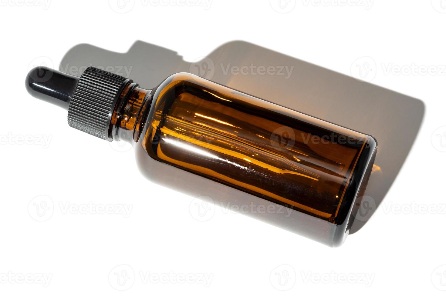 Essential oil amber bottle with pipette isolated on white background photo