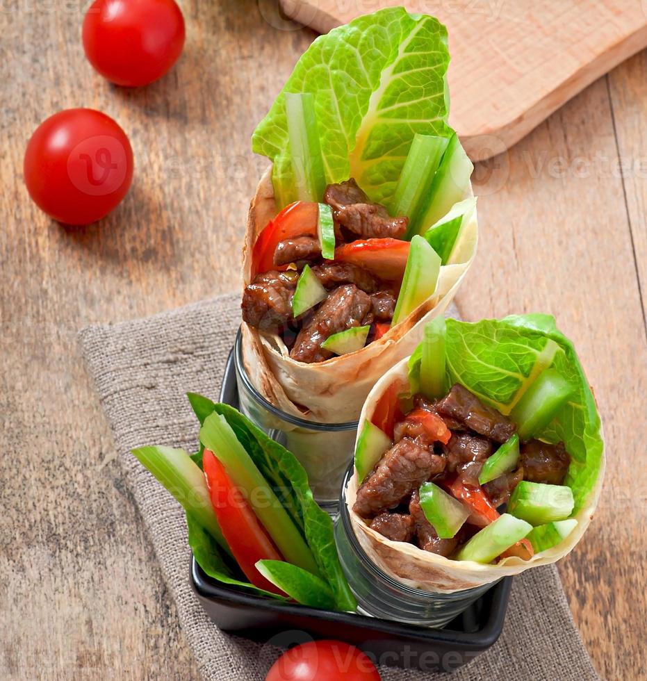 Tortilla wraps with meat and fresh vegetables photo