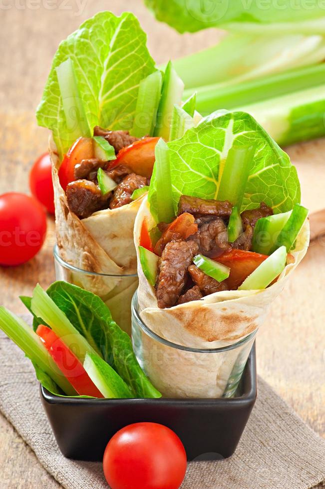 Tortilla wraps with meat and fresh vegetables photo