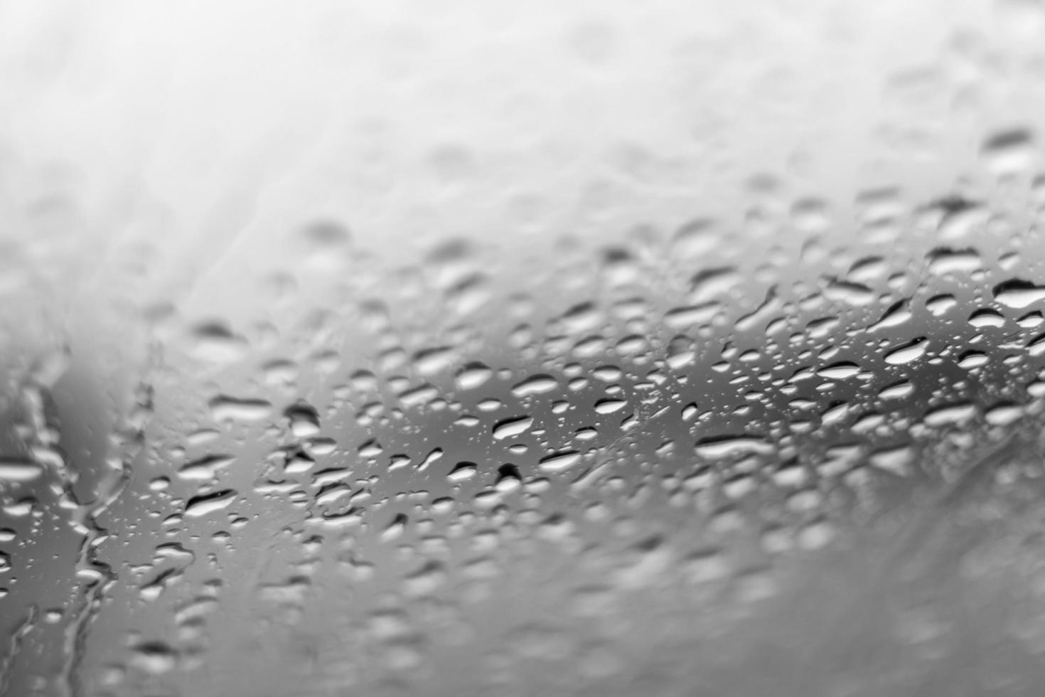 Background blurred, rain drops on the windshield. photo