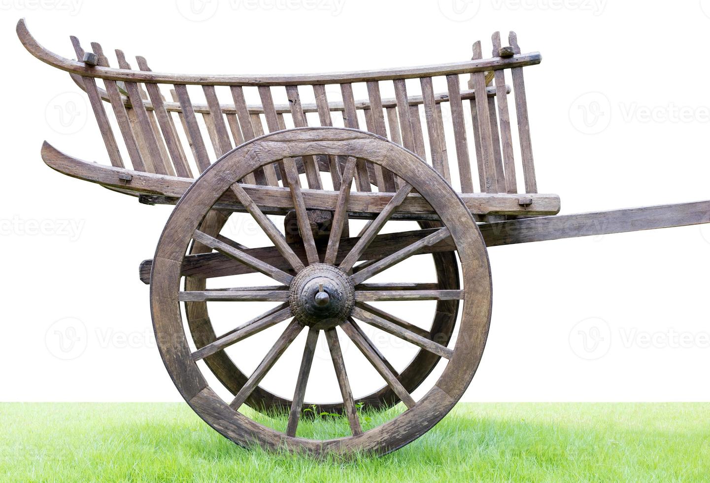 Old wooden wheeled cart wheel on the lawn. photo