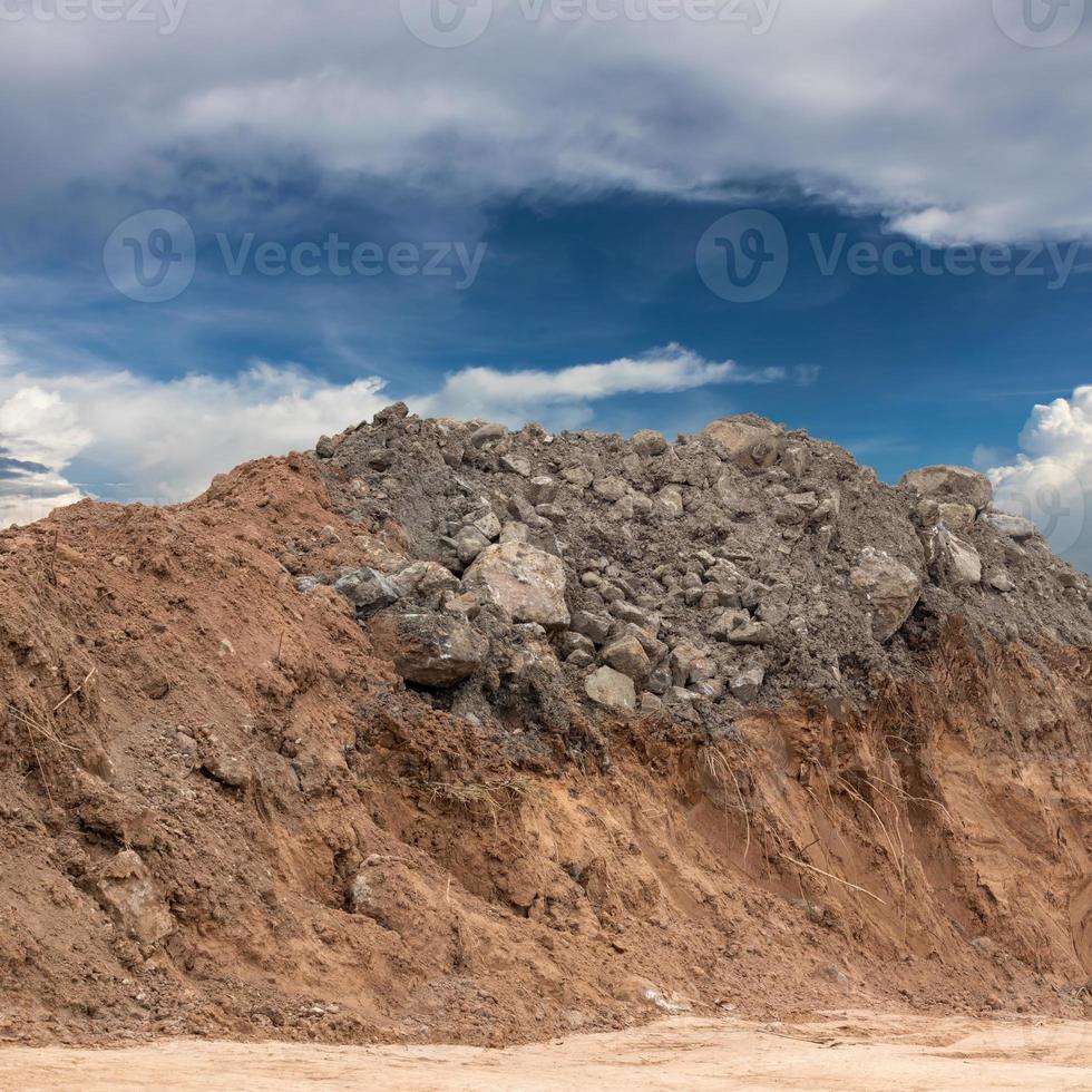 Underneath the ground, dig and pile the rocks with skies. photo