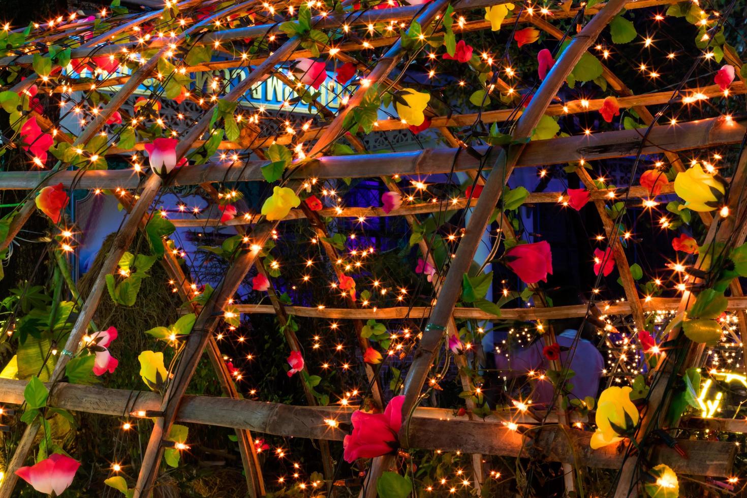 Light and flowers on the bamboo frame. photo