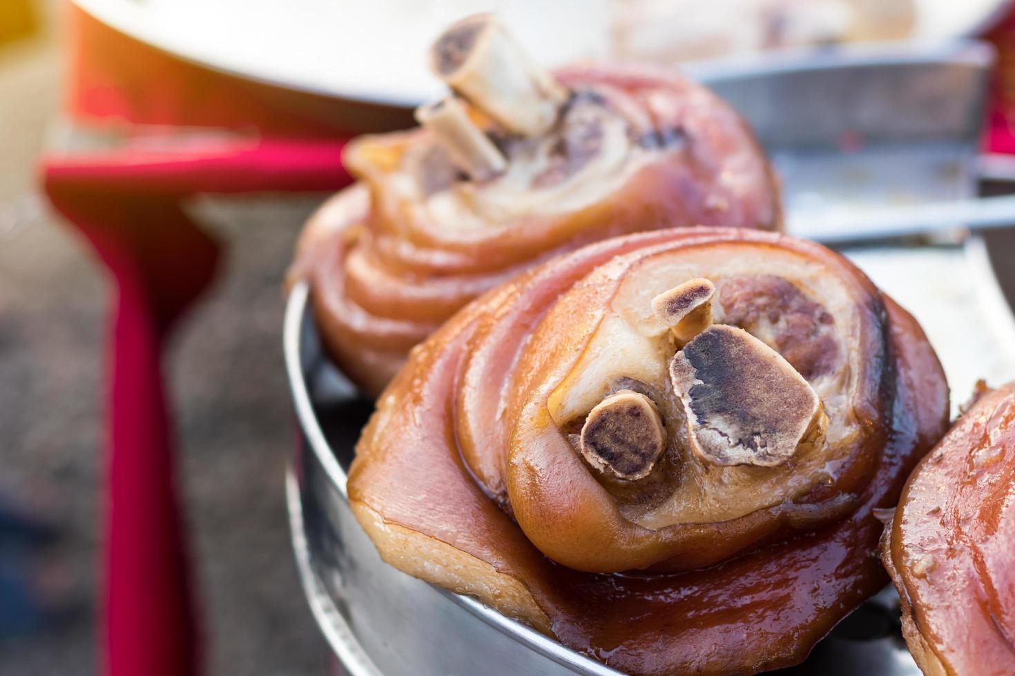 Fat pork legs in a steaming pot. photo