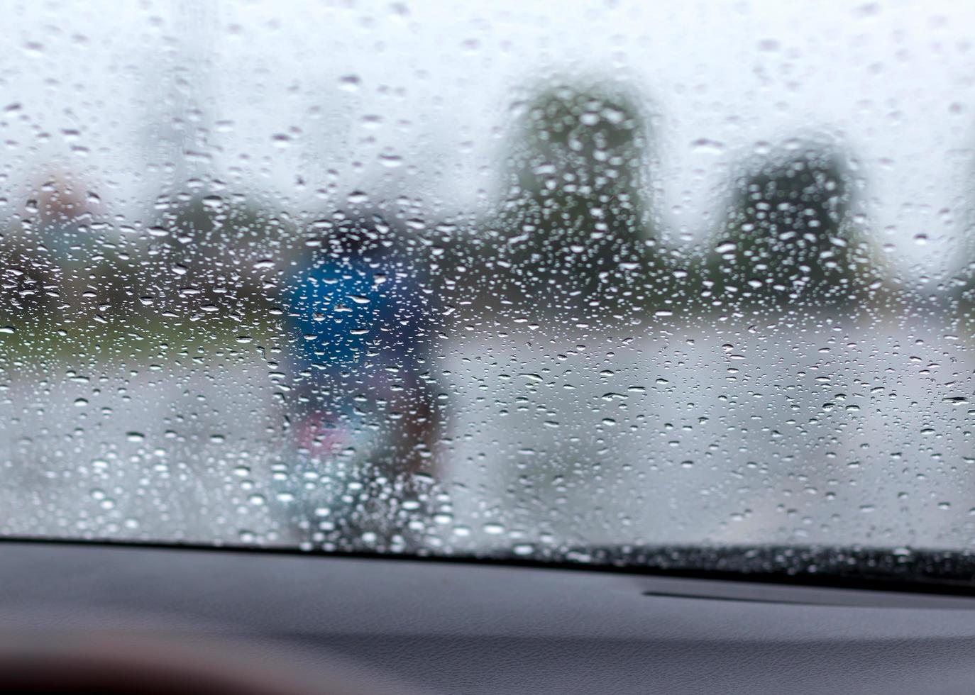 Rain drops on the windshield with the road. photo