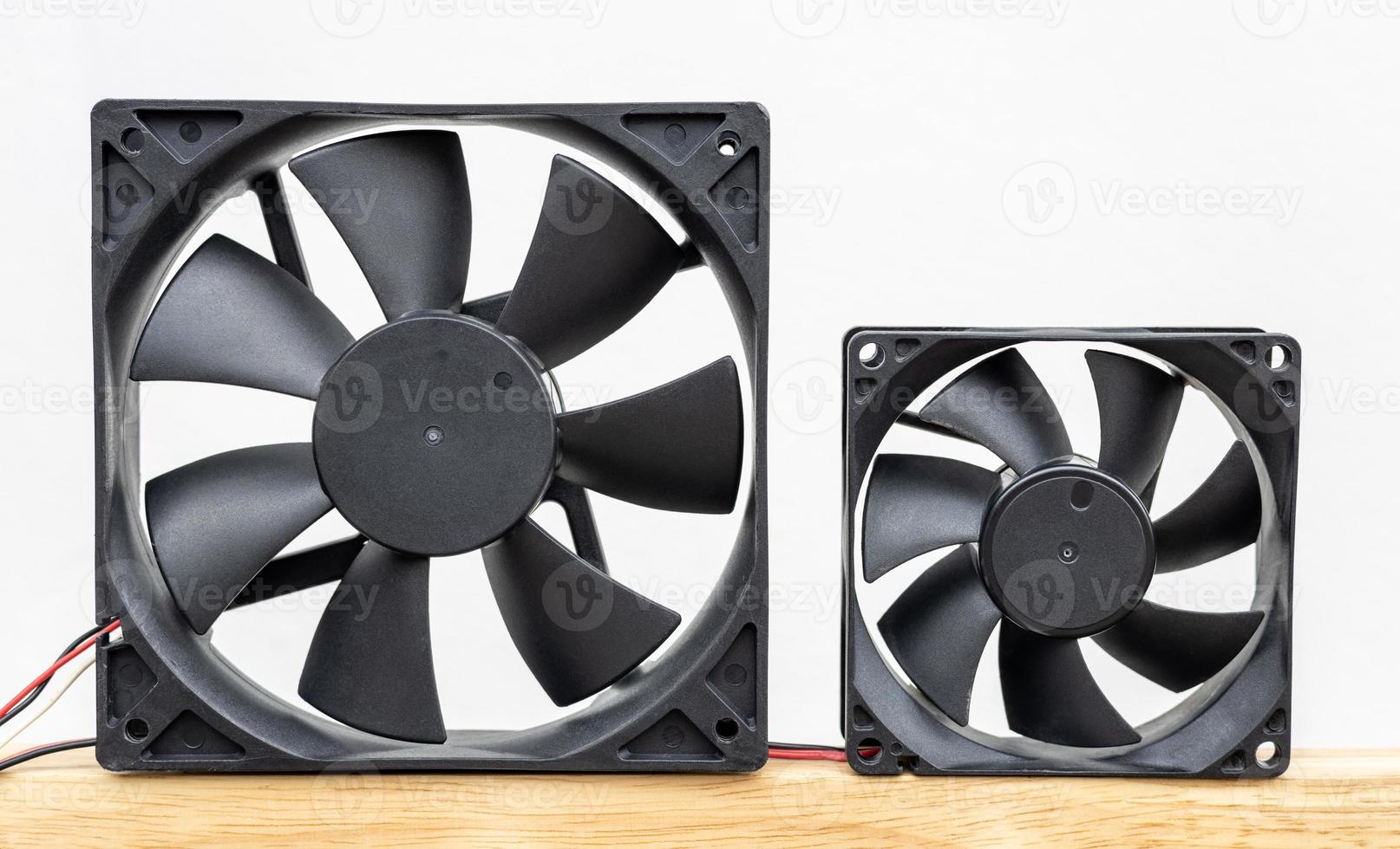 Close-up view of the two computer fans isolates of different sizes. photo