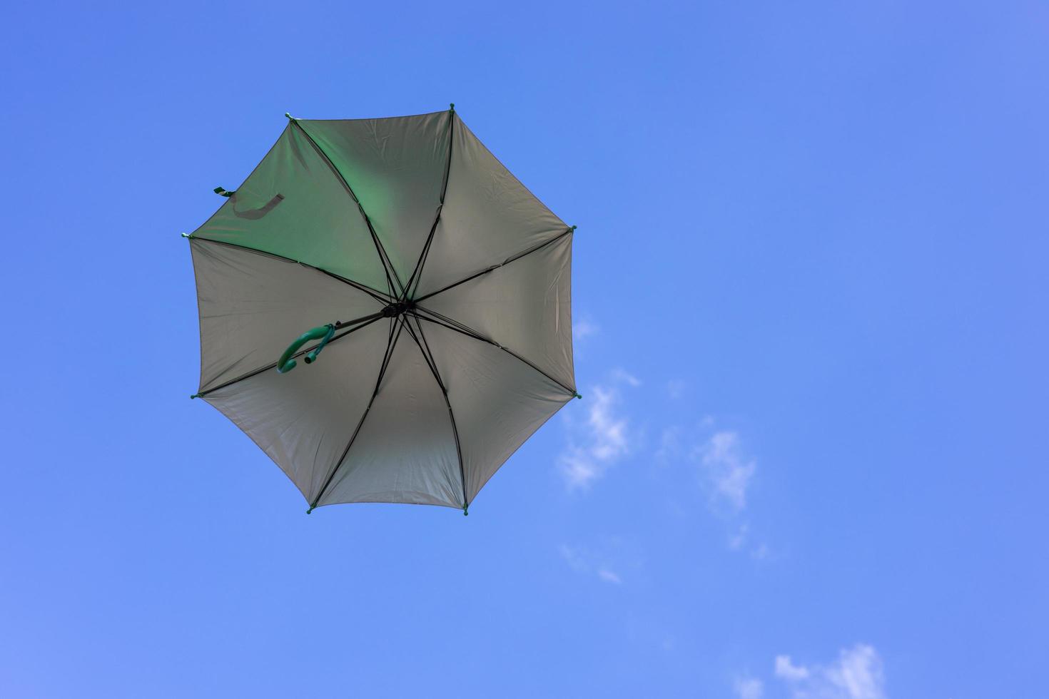 A close-up view from the low, a beautiful opaque bronze umbrella floating freely. photo