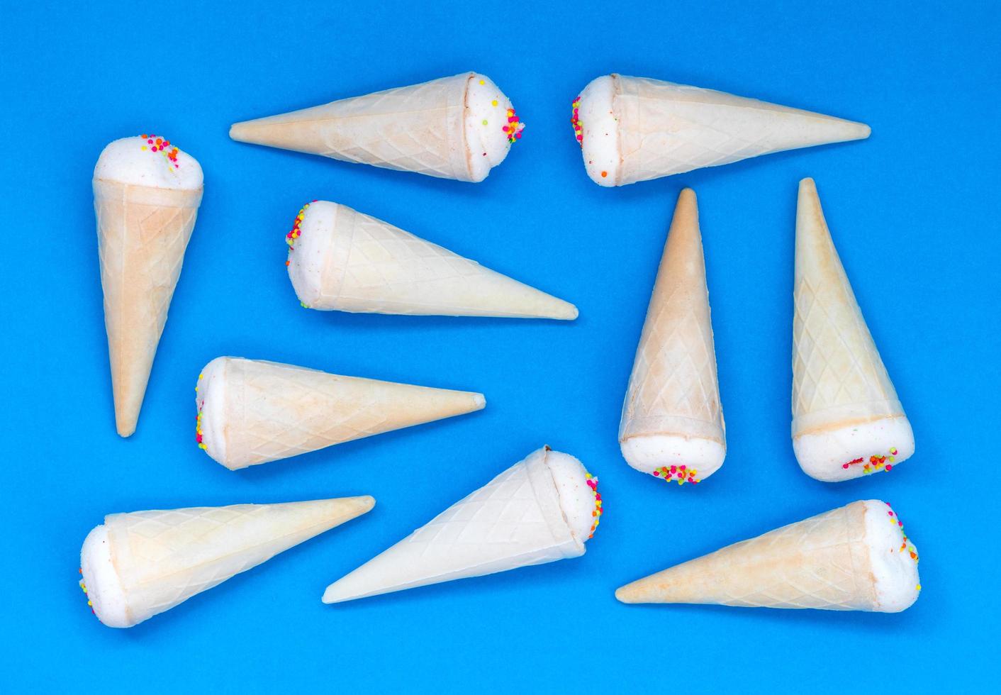 Small ice cream cone on a blue background. photo