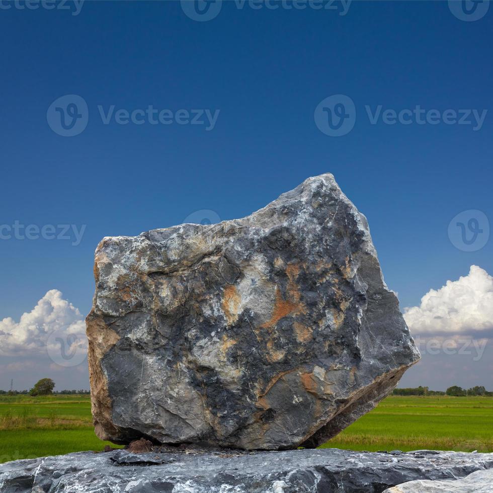 A large granite with sky clouds as a backdrop. photo